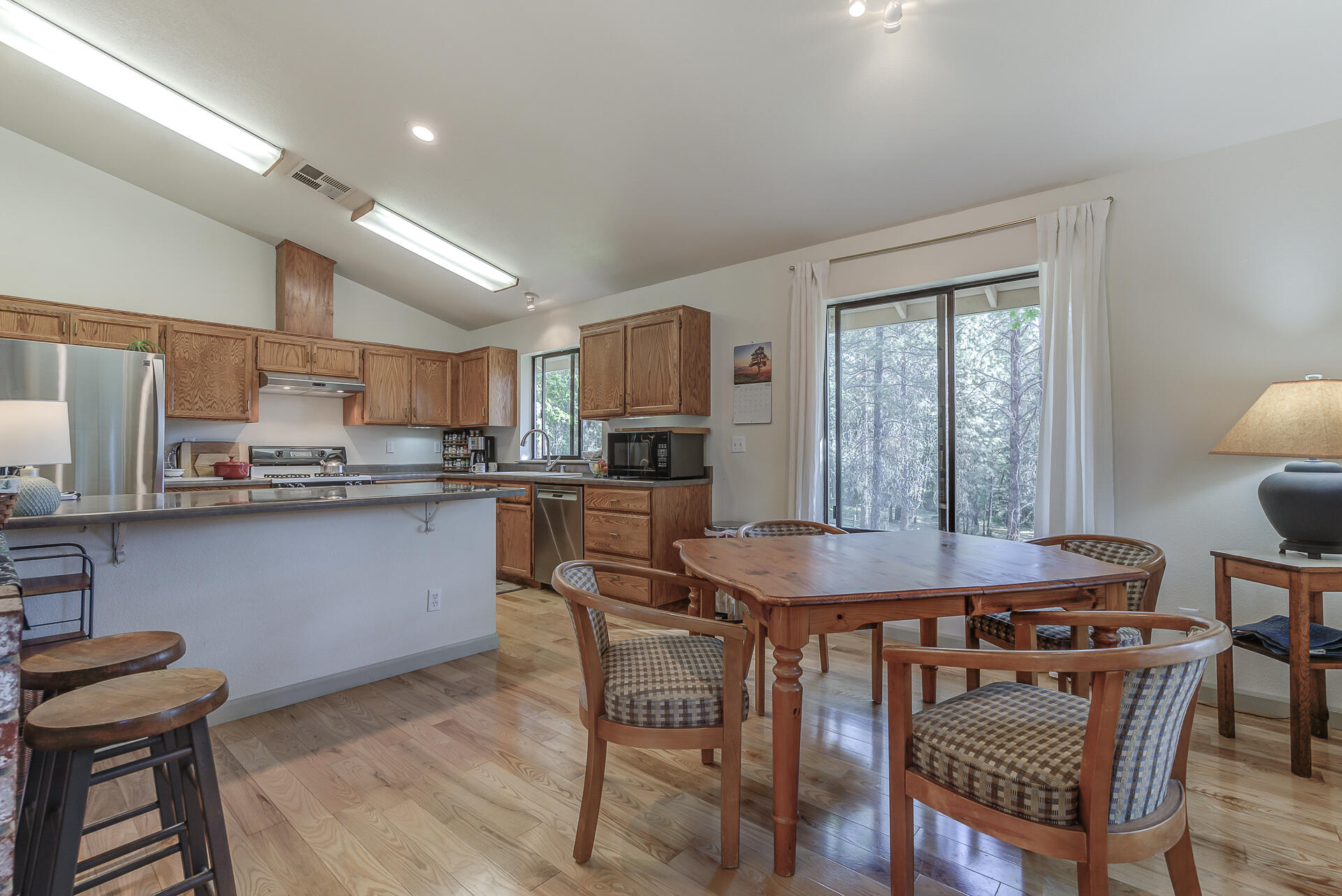 551 Salt Flat Road Lewiston, CA 96052 - Photo 6 of 29 a kitchen with a table chairs a sink dishwasher window and cabinets