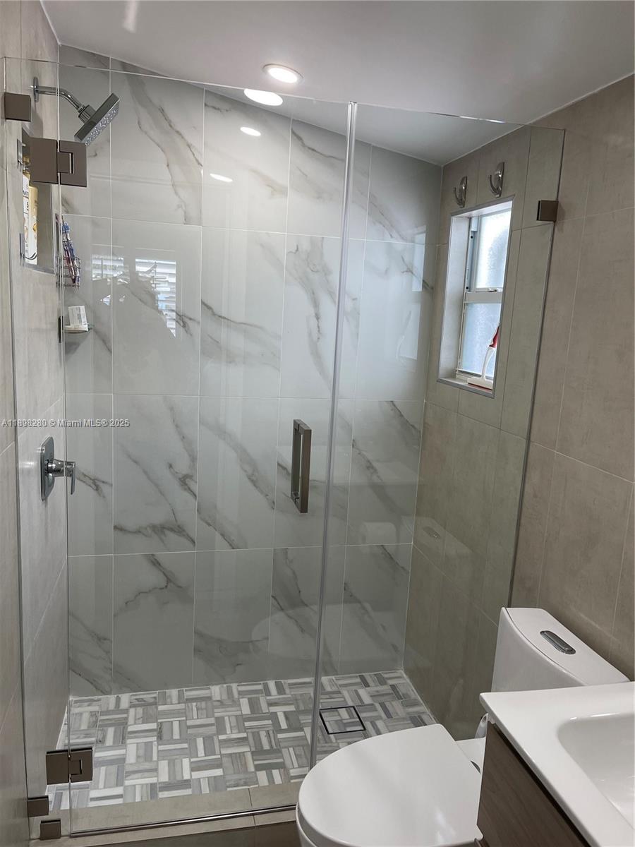 65821 Overseas Highway, Unit 82 Long Key, FL 33001 - Photo 5 of 10 a bathroom with a shower a toilet and a sink