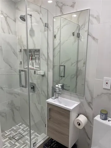 a bathroom with a sink toilet and shower