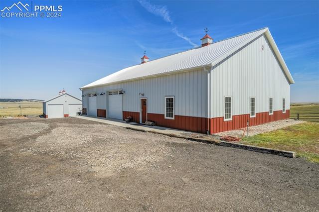 24076 Kobilan Road Calhan, CO 80808 - Photo 40 of 50 View of home's exterior featuring a garage
