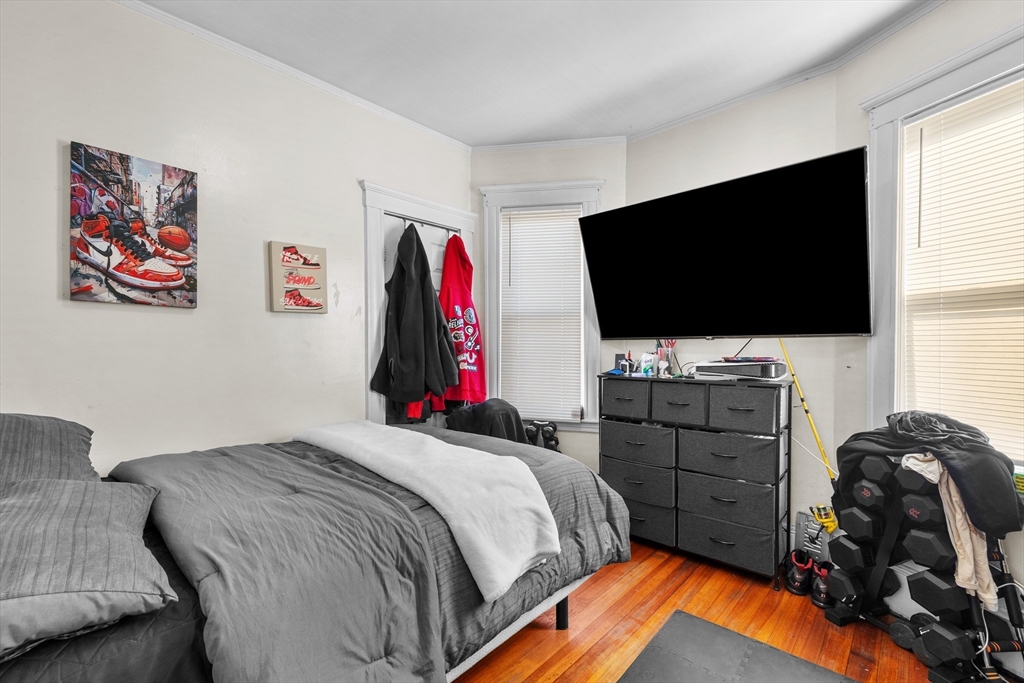 46 Theodore Street Boston, MA 02124 - Photo 13 of 24 a bedroom with a bed and a flat screen tv
