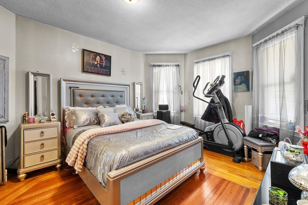 46 Theodore Street Boston, MA 02124 - Photo 14 of 24 a bed room with a bed and a flat tv screen