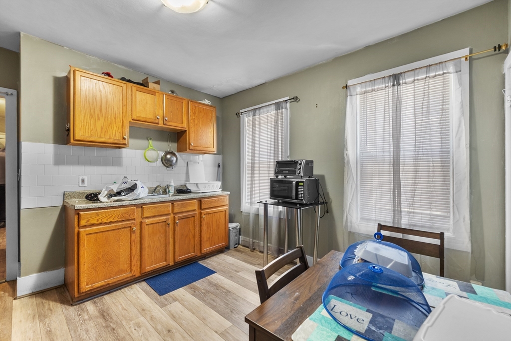 46 Theodore Street Boston, MA 02124 - Photo 17 of 24 a kitchen with sink refrigerator and window