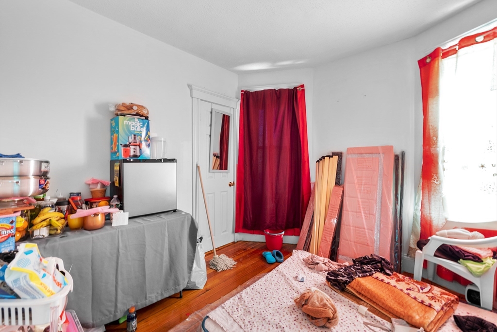 46 Theodore Street Boston, MA 02124 - Photo 2 of 24 a room with furniture and a bed