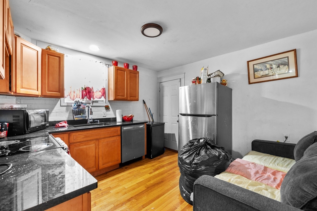 46 Theodore Street Boston, MA 02124 - Photo 3 of 24 a living room with furniture with kitchen view and a window