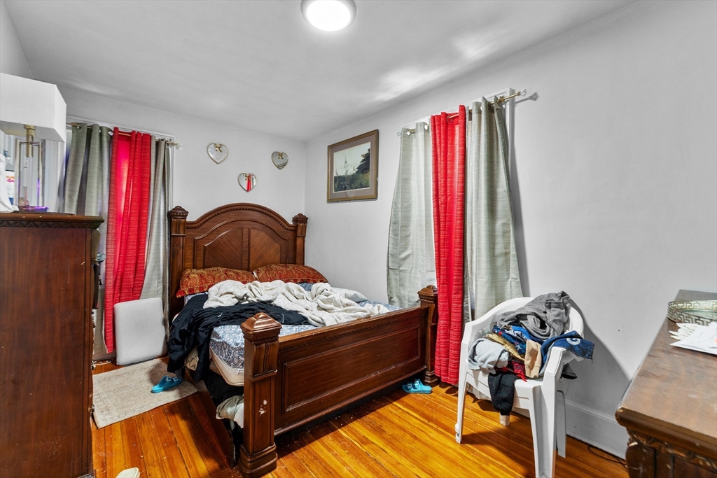46 Theodore Street Boston, MA 02124 - Photo 4 of 24 a bedroom with a bed and a flat tv screen on dresser