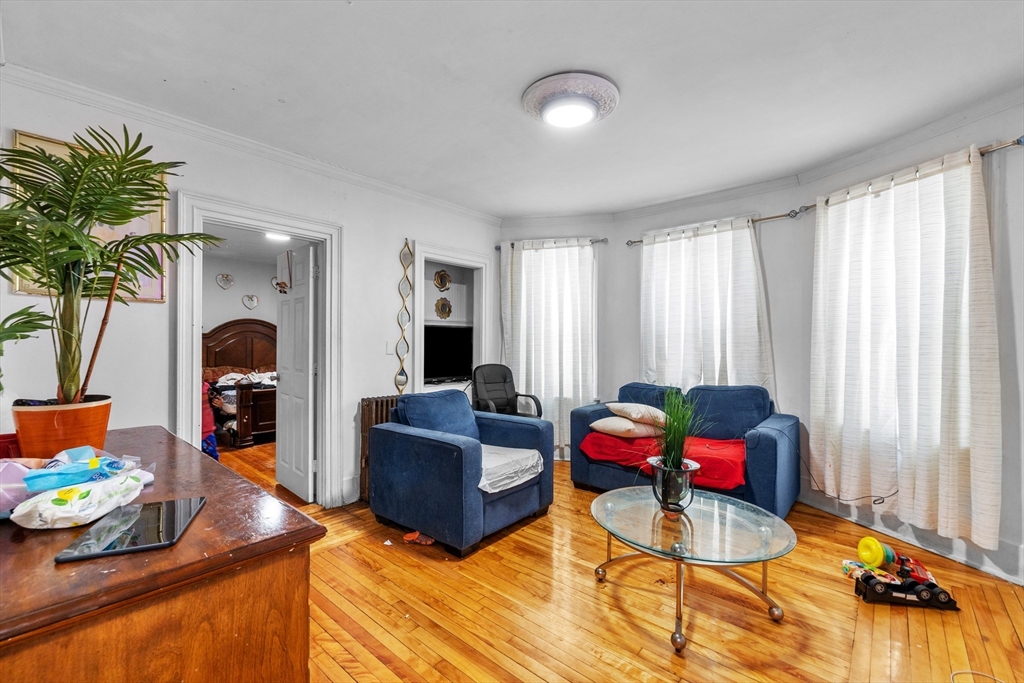46 Theodore Street Boston, MA 02124 - Photo 5 of 24 a living room with furniture and a fireplace