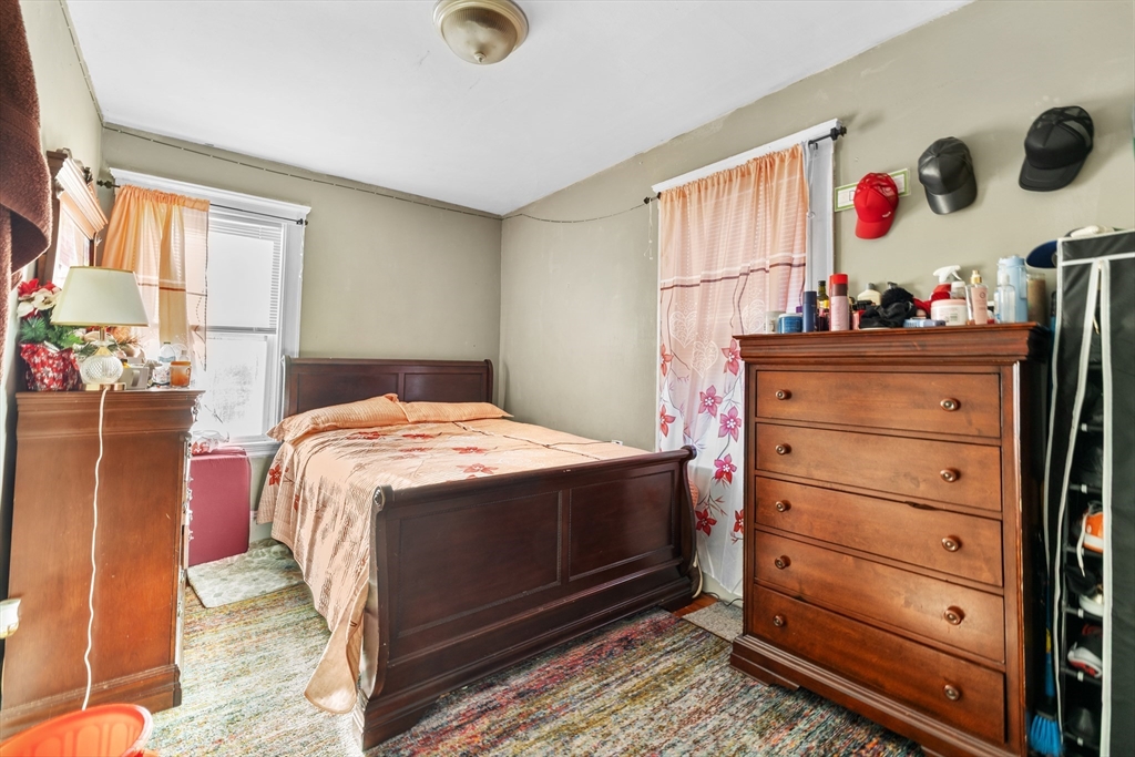 46 Theodore Street Boston, MA 02124 - Photo 7 of 24 a bedroom with a bed and a dresser