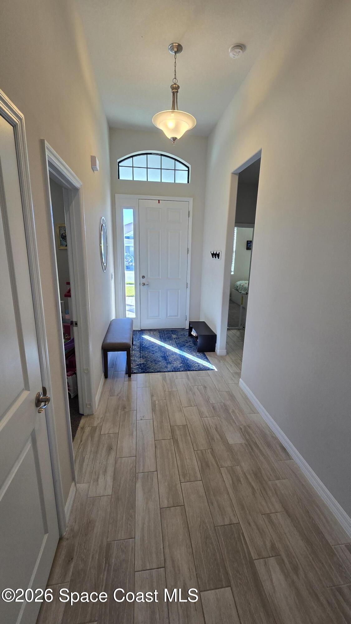 8137 Dobre Way Melbourne, FL 32940 - Photo 13 of 25 wooden floor in an empty room with a window