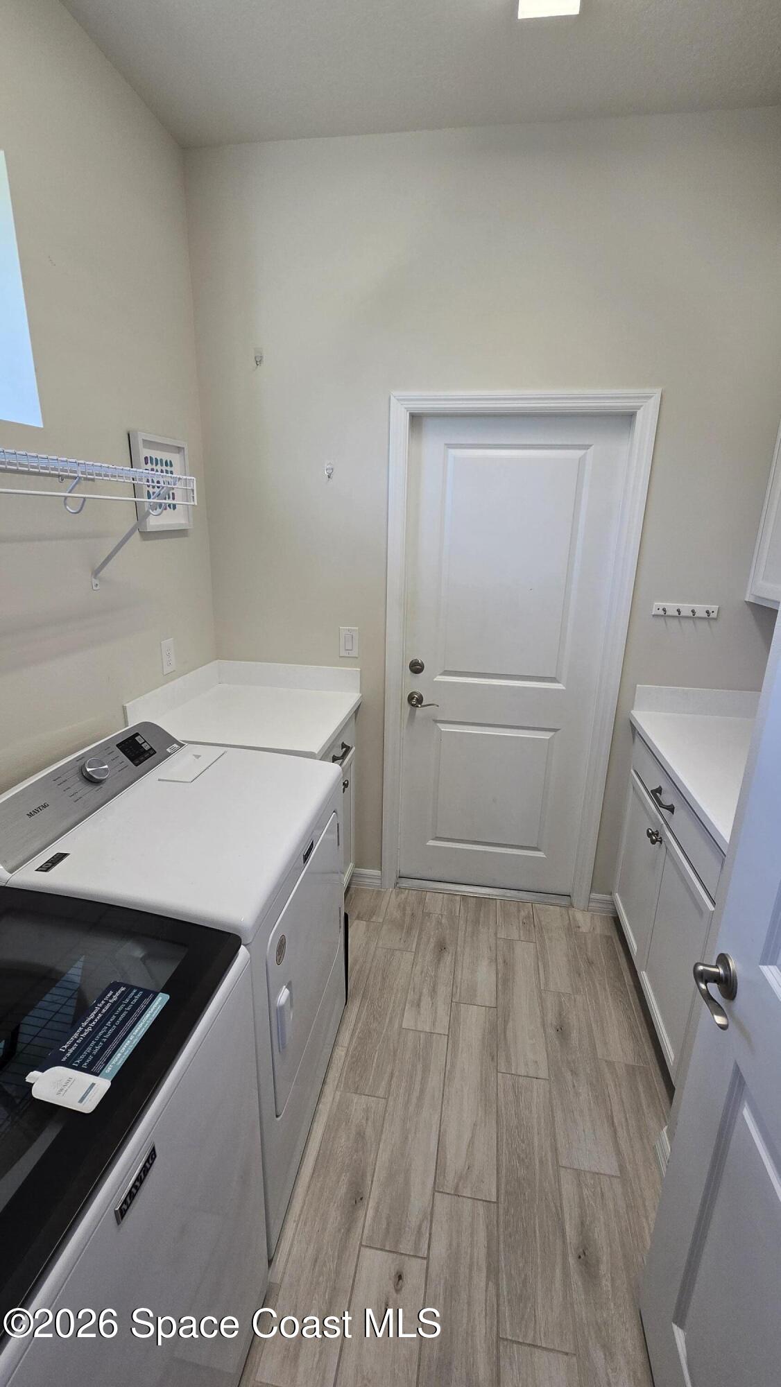 8137 Dobre Way Melbourne, FL 32940 - Photo 14 of 25 a storage room with wooden floor