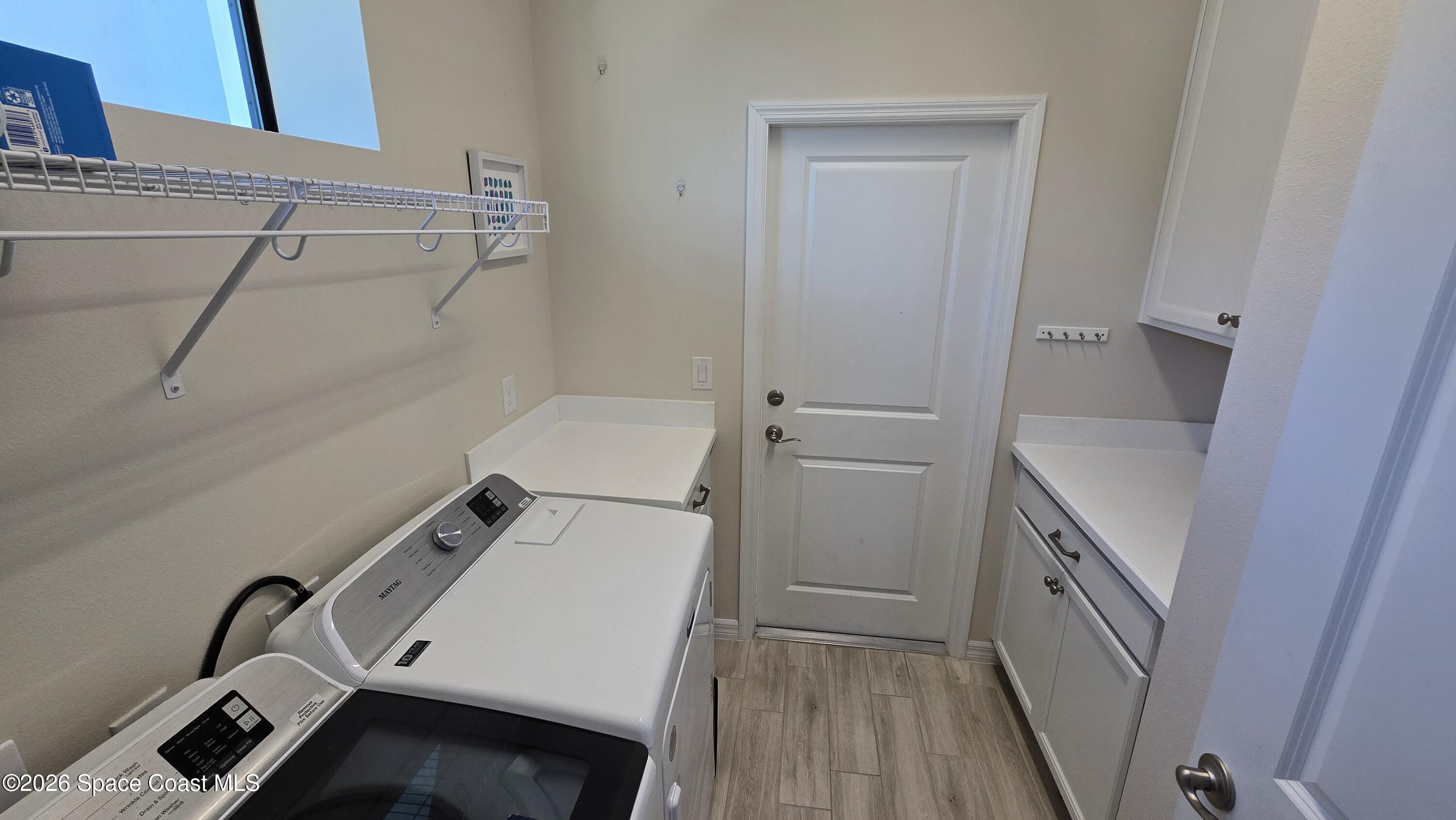 8137 Dobre Way Melbourne, FL 32940 - Photo 15 of 25 a utility room with dryer and washer