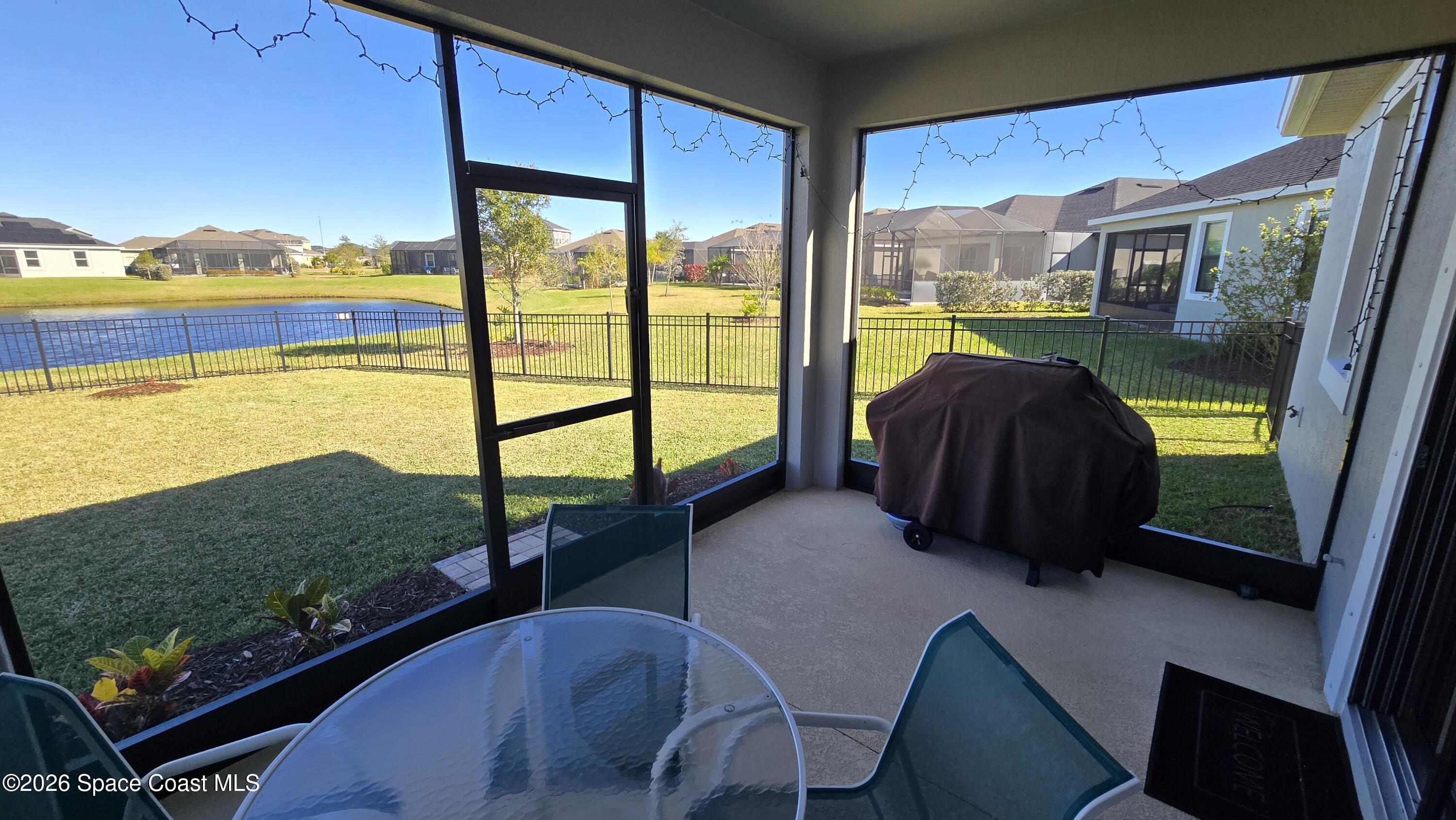 8137 Dobre Way Melbourne, FL 32940 - Photo 17 of 25 a view of a balcony with chair and a floor to ceiling window