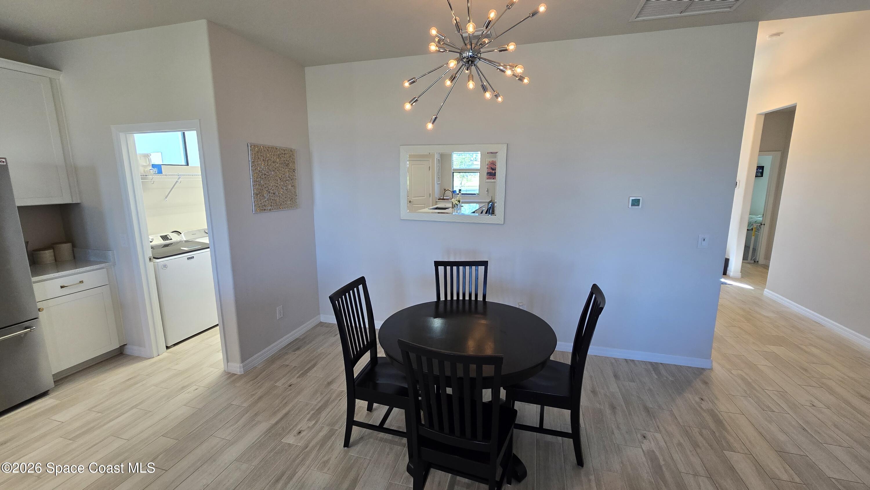 8137 Dobre Way Melbourne, FL 32940 - Photo 3 of 25 a view of a dining room with furniture and wooden floor