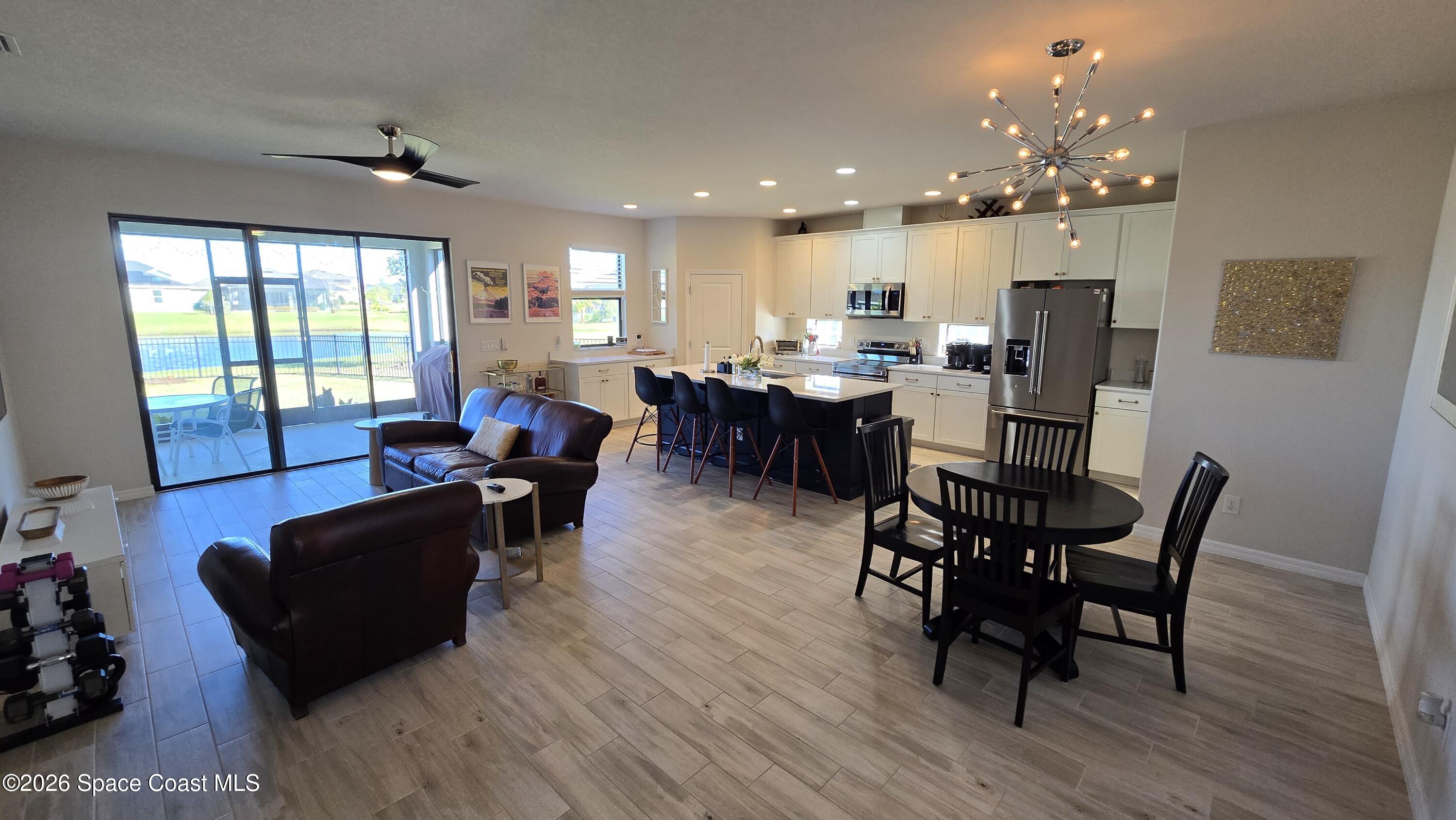 8137 Dobre Way Melbourne, FL 32940 - Photo 5 of 25 a living room with furniture and a dining table