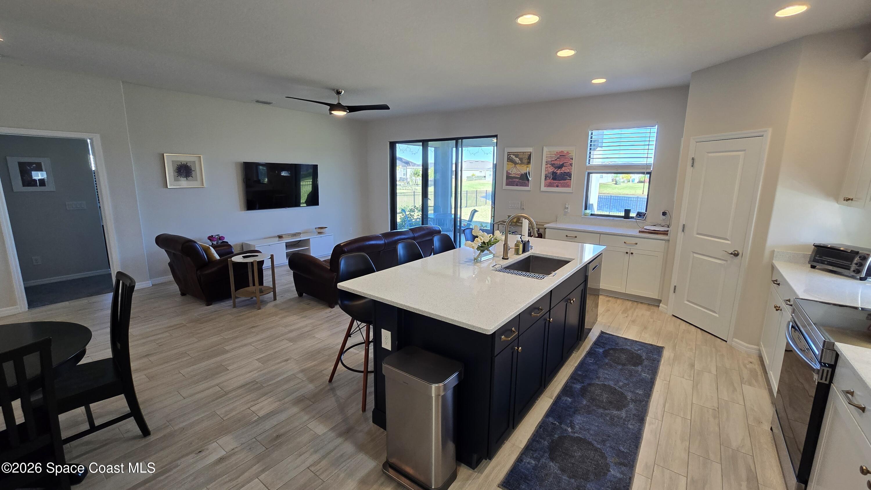 8137 Dobre Way Melbourne, FL 32940 - Photo 6 of 25 a view of a kitchen area with furniture and wooden floor