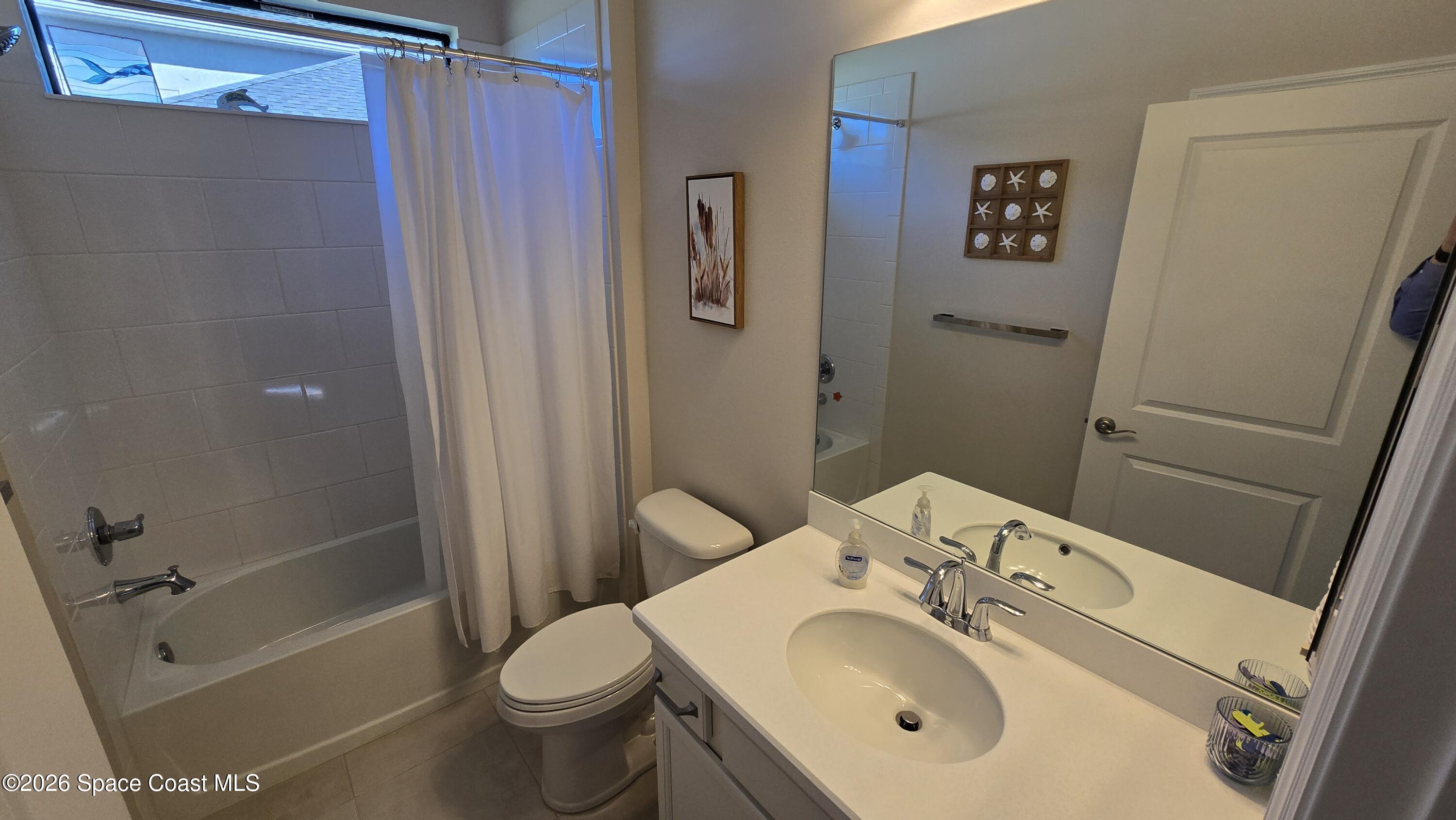 8137 Dobre Way Melbourne, FL 32940 - Photo 7 of 25 a bathroom with a sink toilet and shower