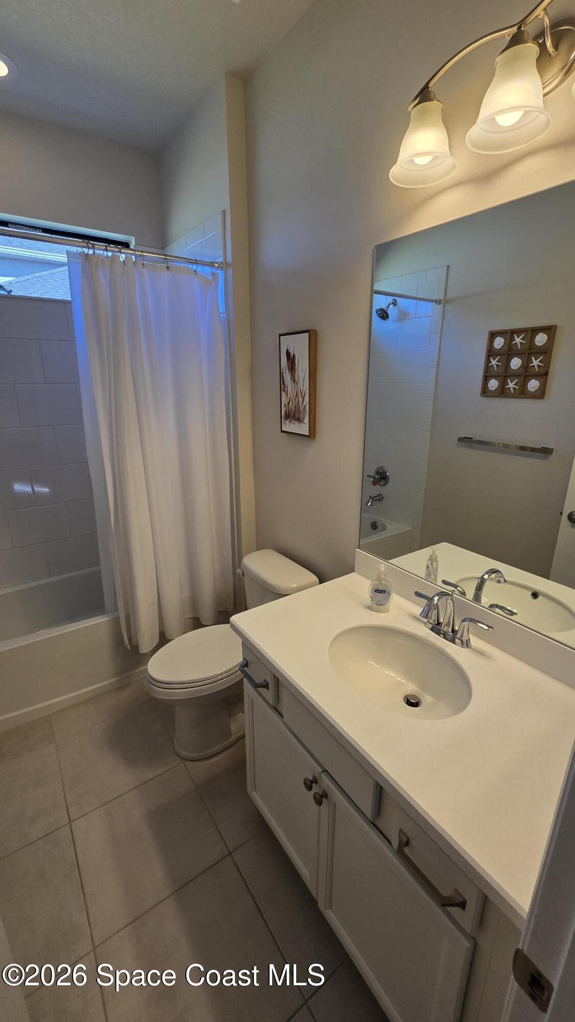 8137 Dobre Way Melbourne, FL 32940 - Photo 8 of 25 a bathroom with a sink a toilet and shower