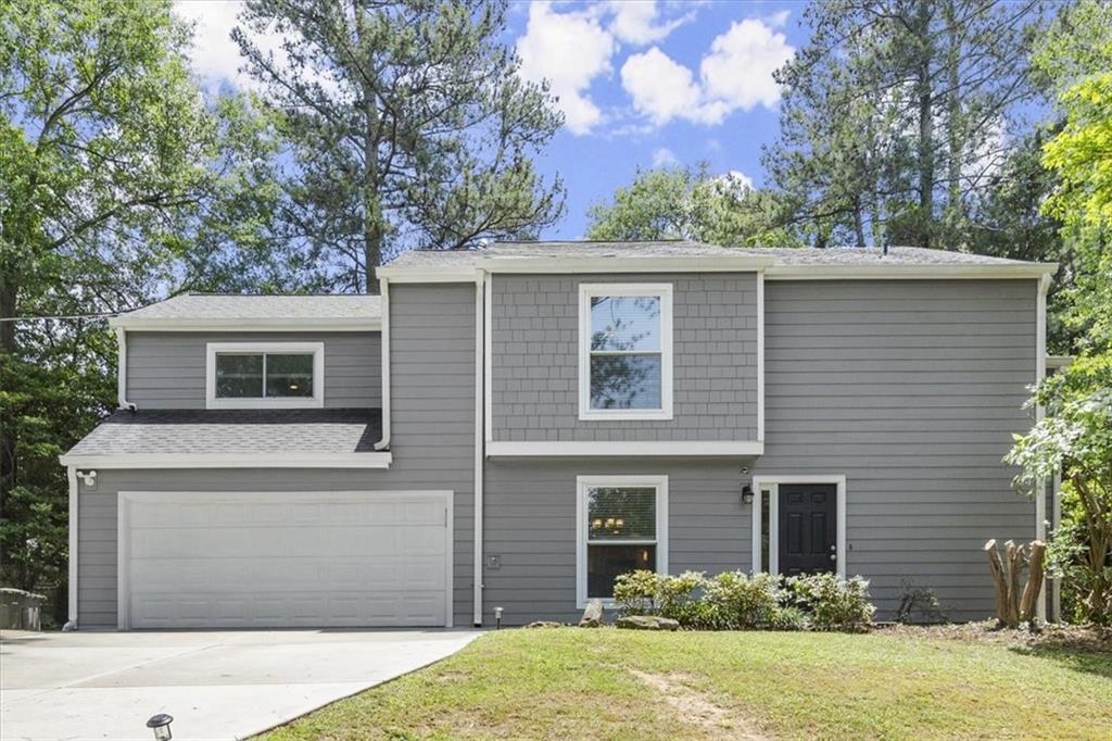 15 Rhodes Drive Southeast Marietta, GA 30068 - Photo 1 of 1 a front view of a house with a yard and garage