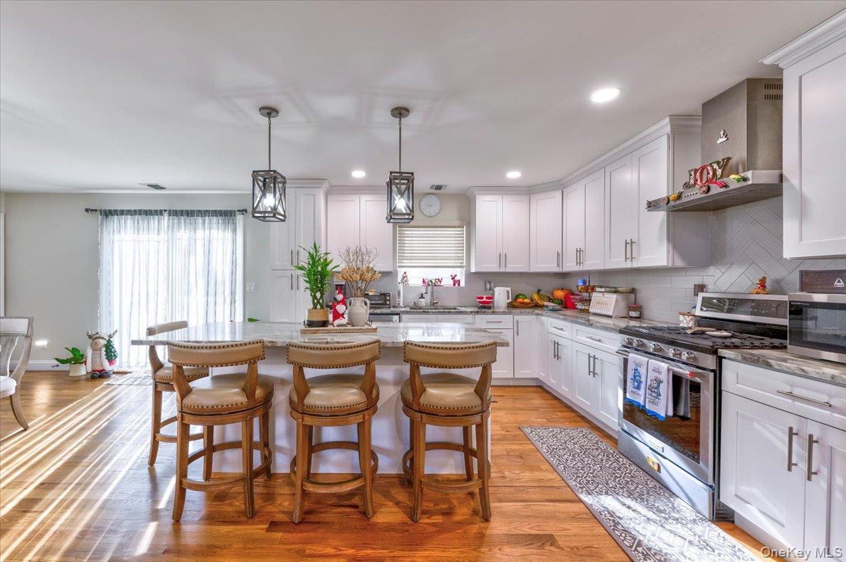 468 Granny Road Medford, NY 11763 - Photo 12 of 42 a kitchen with a table and chairs in it