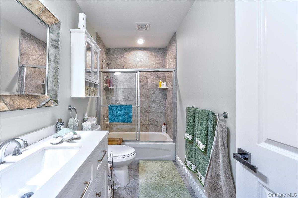 468 Granny Road Medford, NY 11763 - Photo 13 of 42 a bathroom with a sink a toilet a mirror and shower