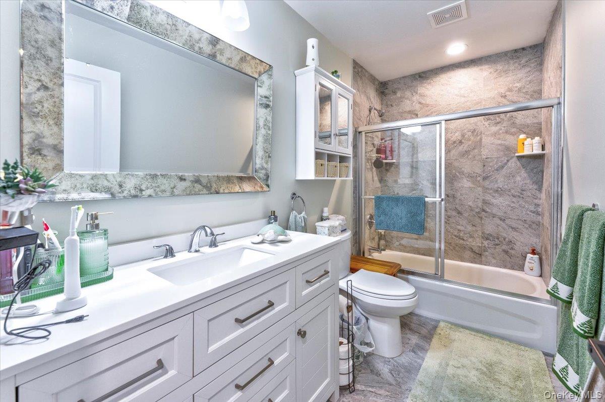 468 Granny Road Medford, NY 11763 - Photo 14 of 42 a bathroom with a double vanity sink toilet and shower