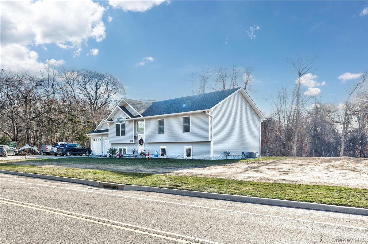 468 Granny Road Medford, NY 11763 - Photo 2 of 42 a view of a house with a big yard and large trees