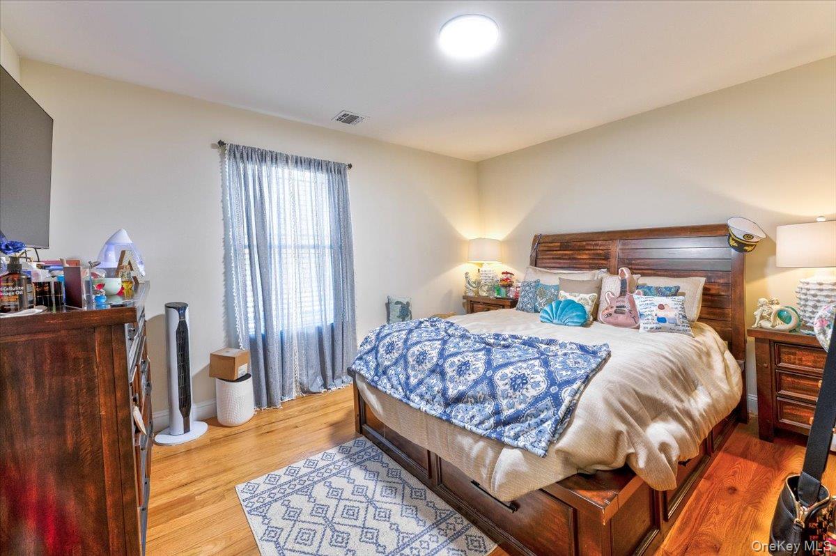 468 Granny Road Medford, NY 11763 - Photo 22 of 42 a bedroom with a bed and wooden floor