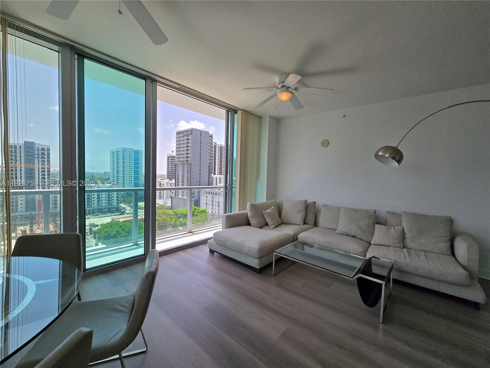 79 Southwest 12th Street, Unit 1701S Miami, FL 33130 - Photo 19 of 25 a living room with furniture and a large window