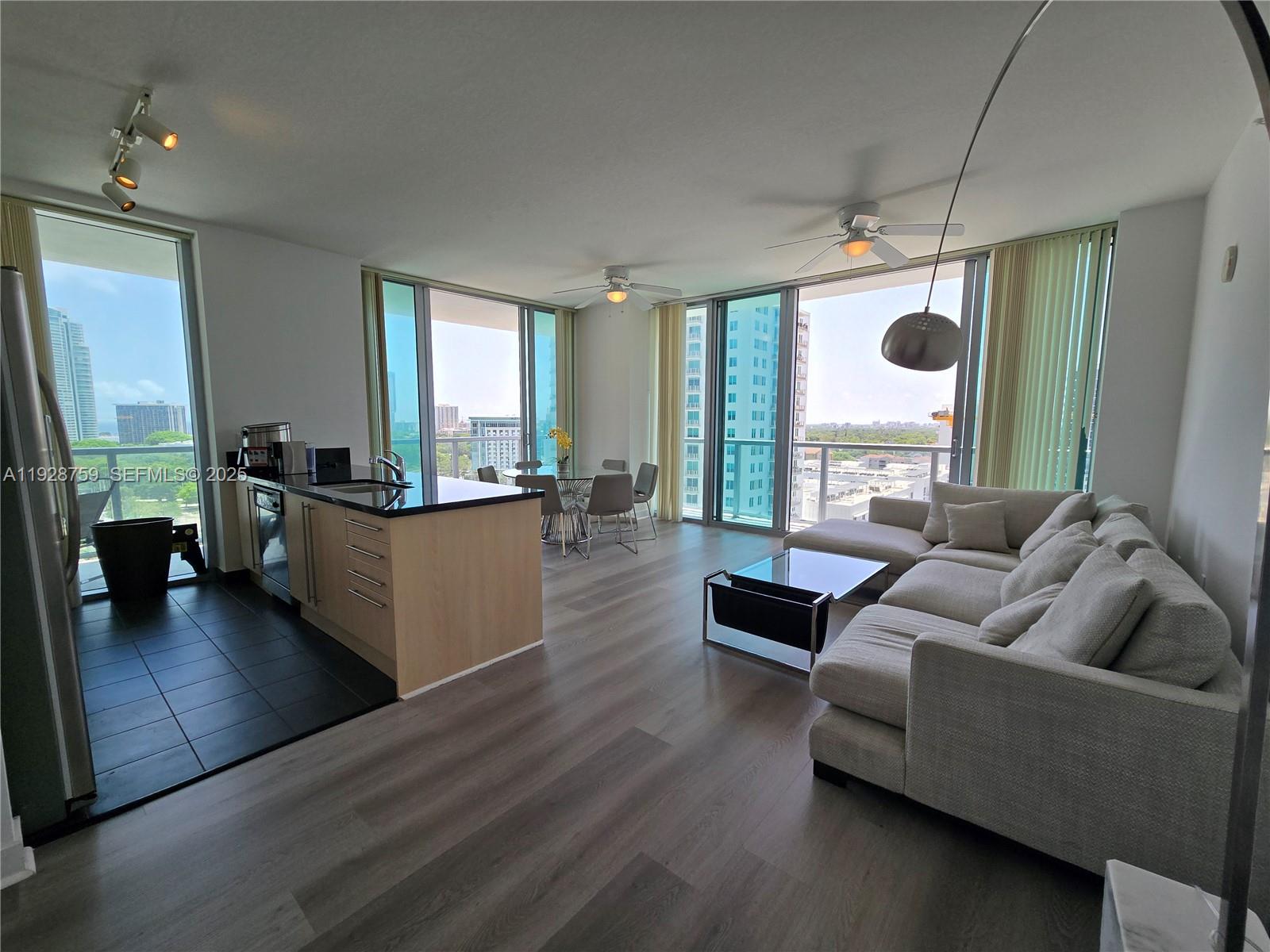 79 Southwest 12th Street, Unit 1701S Miami, FL 33130 - Photo 2 of 25 a living room with furniture and a large window