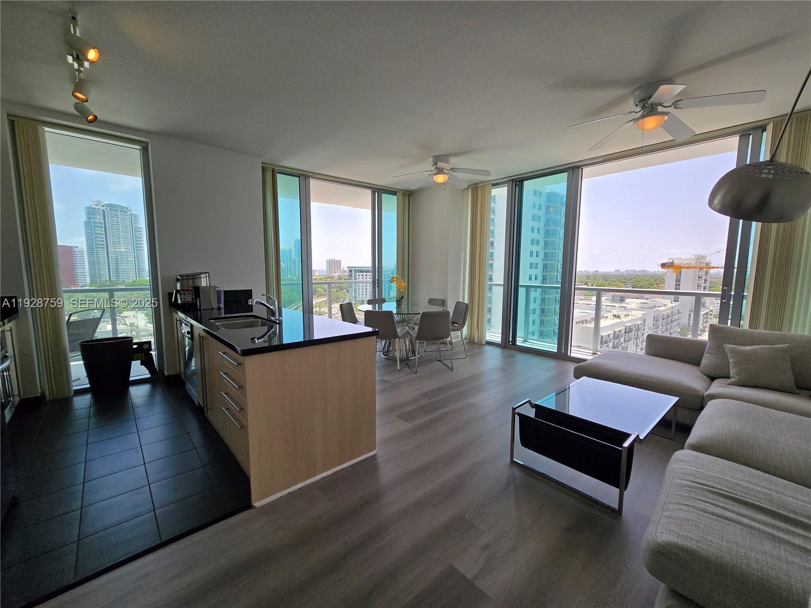 79 Southwest 12th Street, Unit 1701S Miami, FL 33130 - Photo 23 of 25 a living room with furniture and a large window