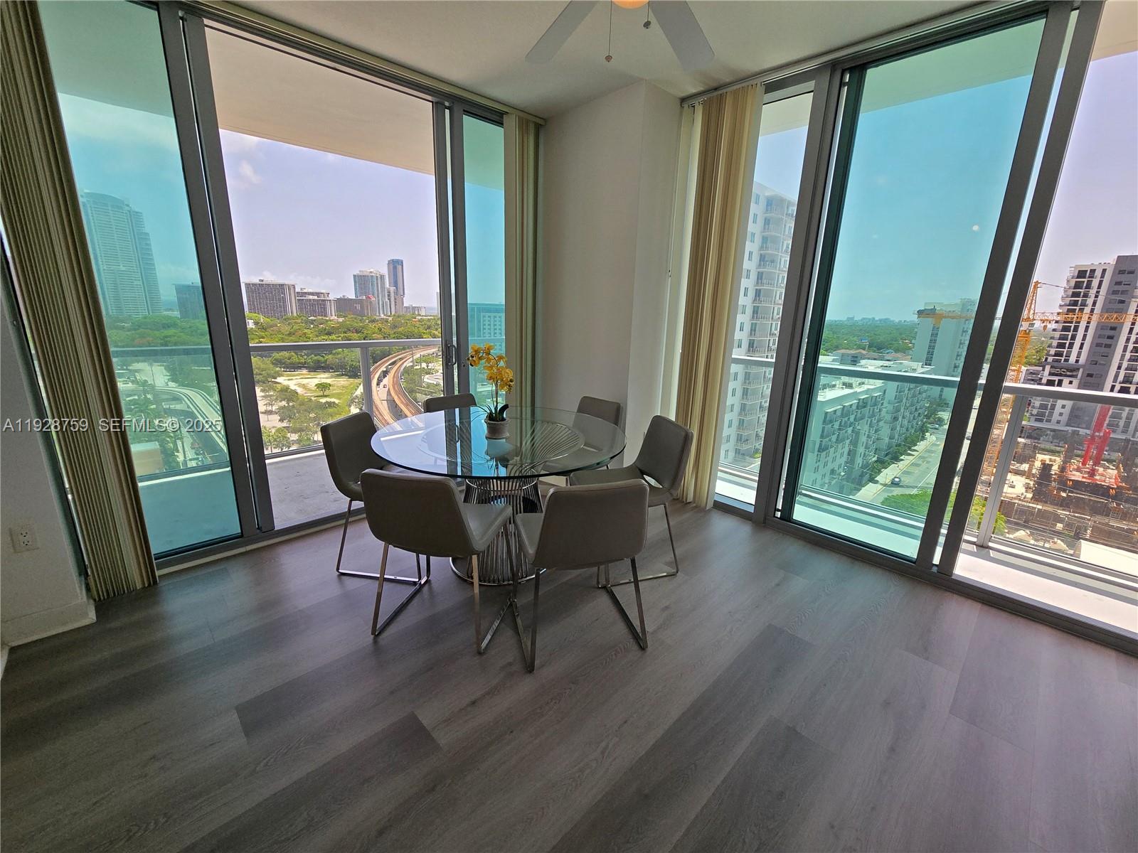 79 Southwest 12th Street, Unit 1701S Miami, FL 33130 - Photo 4 of 25 a dining room with furniture and wooden floor
