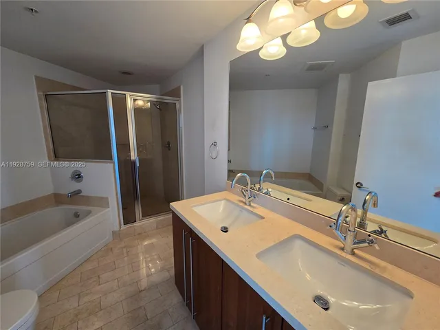a bathroom with a tub sink and mirror