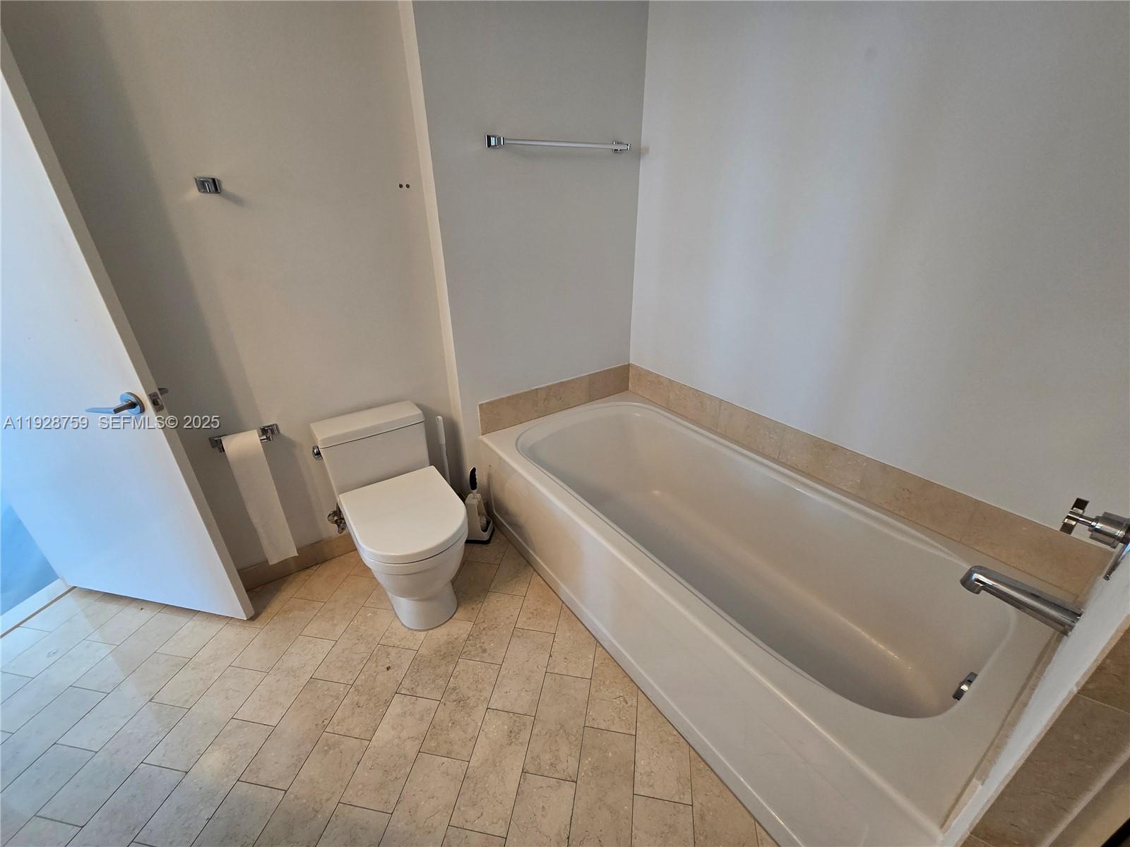 79 Southwest 12th Street, Unit 1701S Miami, FL 33130 - Photo 10 of 25 a bathroom with a toilet and a sink