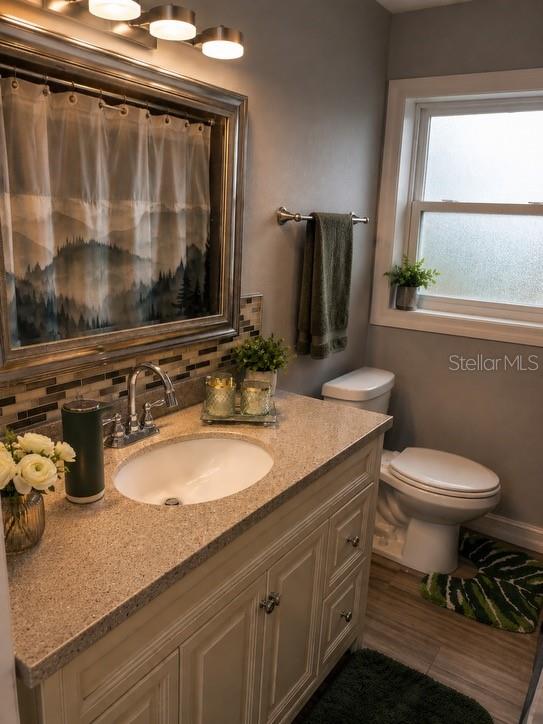 1623 Wavecrest Street Merritt Island, FL 32952 - Photo 13 of 26 a bathroom with a granite countertop sink toilet and shower
