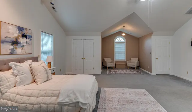 a spacious bedroom with a bed and window