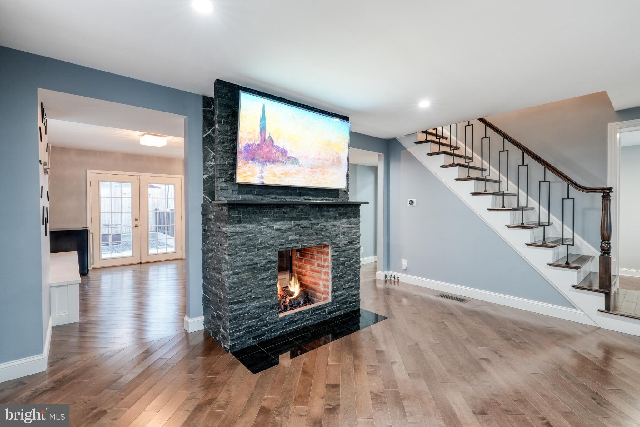 9502 Hilspach Street Philadelphia, PA 19115 - Photo 14 of 53 a living room with fireplace furniture and a flat screen tv
