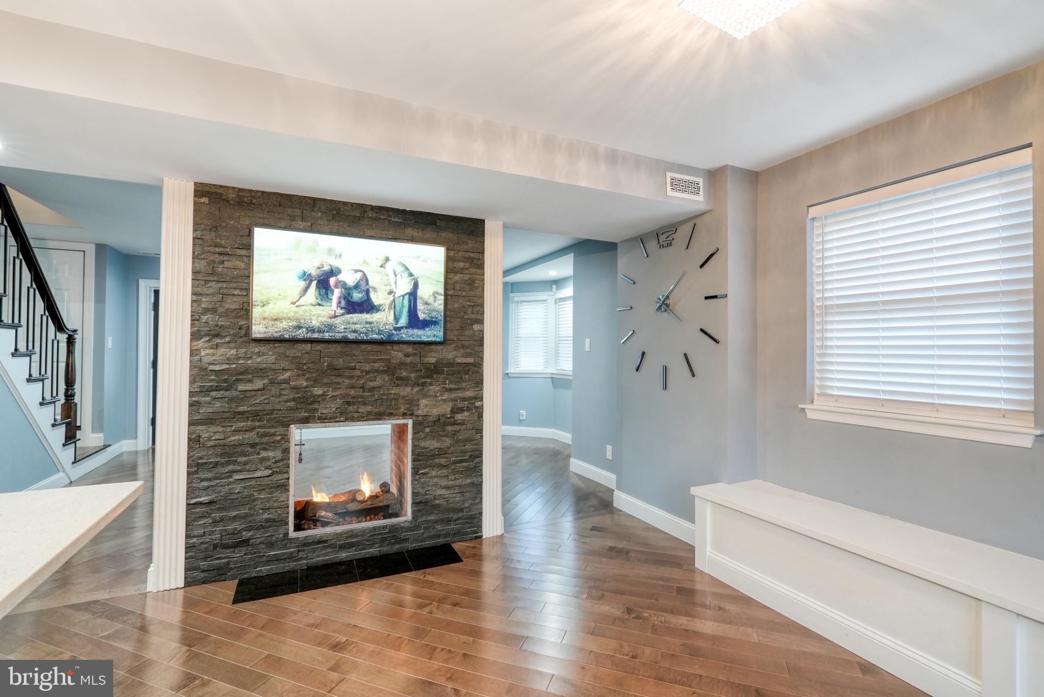 9502 Hilspach Street Philadelphia, PA 19115 - Photo 19 of 53 a living room with furniture a fireplace and a large window