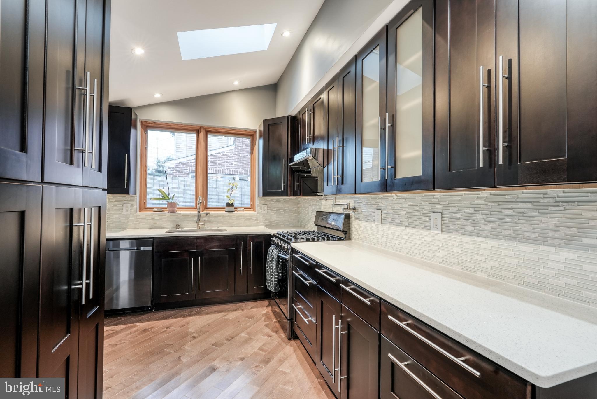 9502 Hilspach Street Philadelphia, PA 19115 - Photo 31 of 53 a kitchen with stainless steel appliances granite countertop a sink and stove