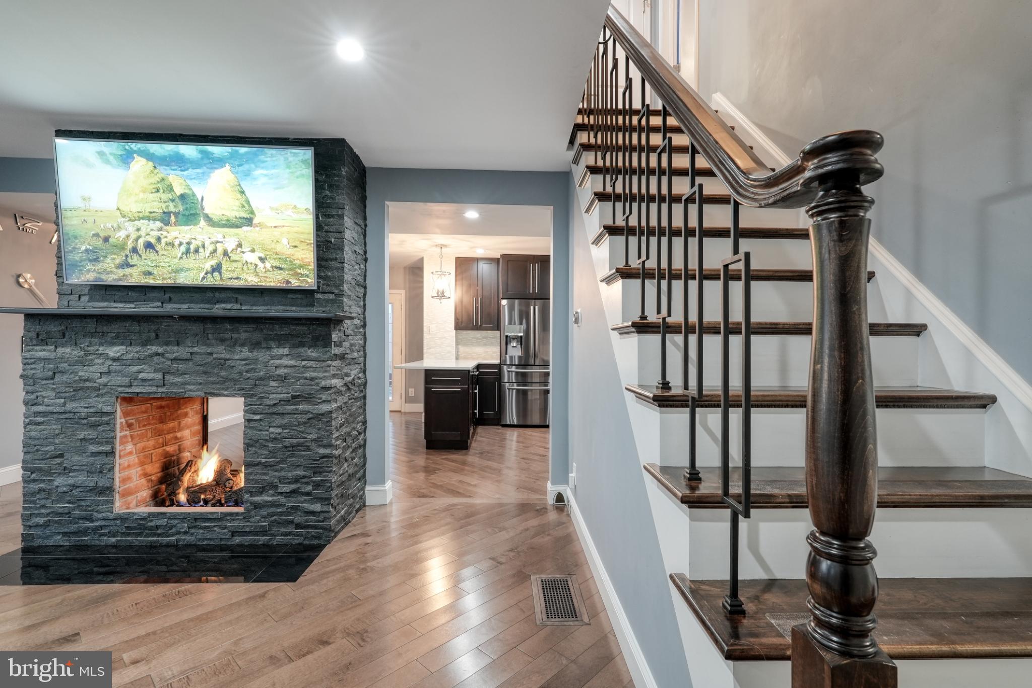 9502 Hilspach Street Philadelphia, PA 19115 - Photo 35 of 53 a view of a living room with a wooden floor and a fireplace