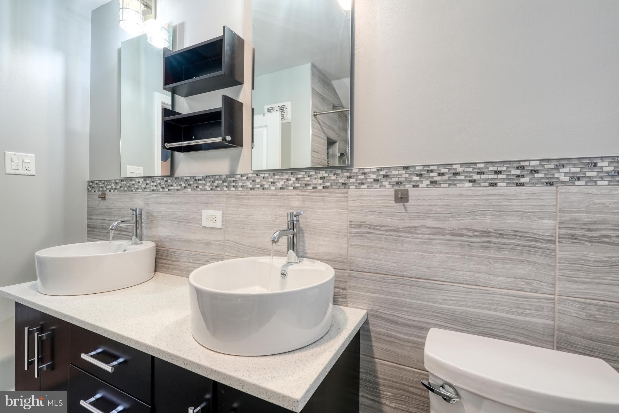 9502 Hilspach Street Philadelphia, PA 19115 - Photo 45 of 53 a bathroom with a toilet a sink and mirror