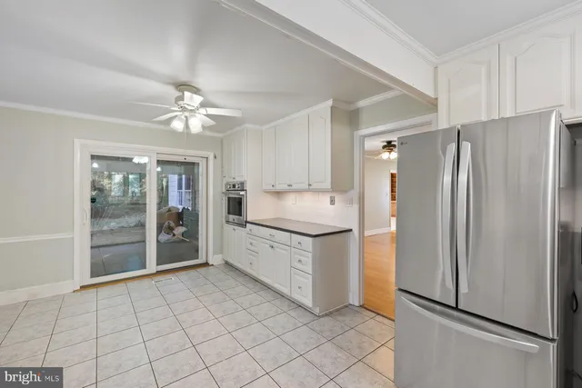 a kitchen with granite countertop a refrigerator and a sink