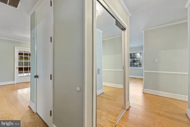 a view of a hallway with wooden floor and entryway