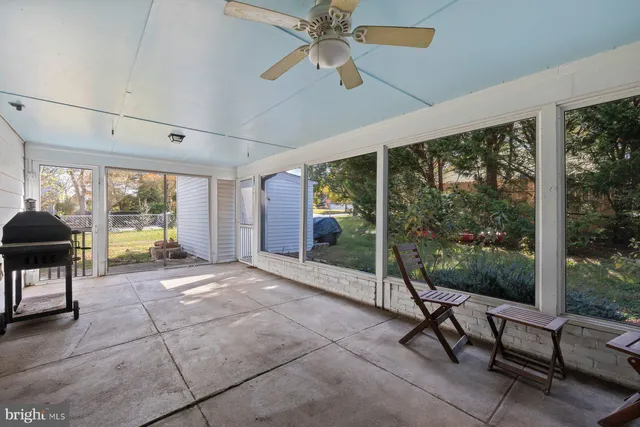 a view of a room with furniture wooden floor and a floor to ceiling window