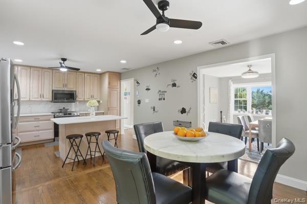 31 Laura Road Monroe, NY 10950 - Photo 14 of 39 a kitchen with stainless steel appliances kitchen island granite countertop a dining table chairs and a refrigerator