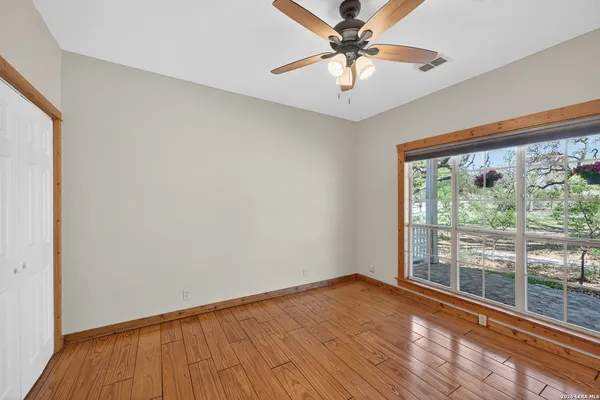 wooden floor in an empty room with a window