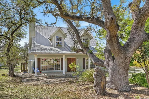 front view of a house with a tree in front