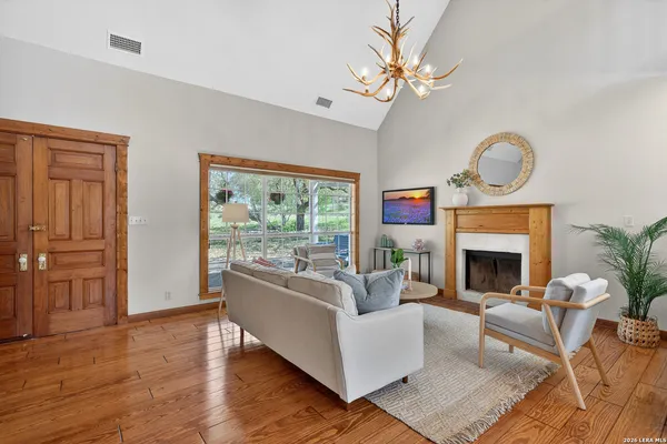 a living room with furniture a fireplace and a large window