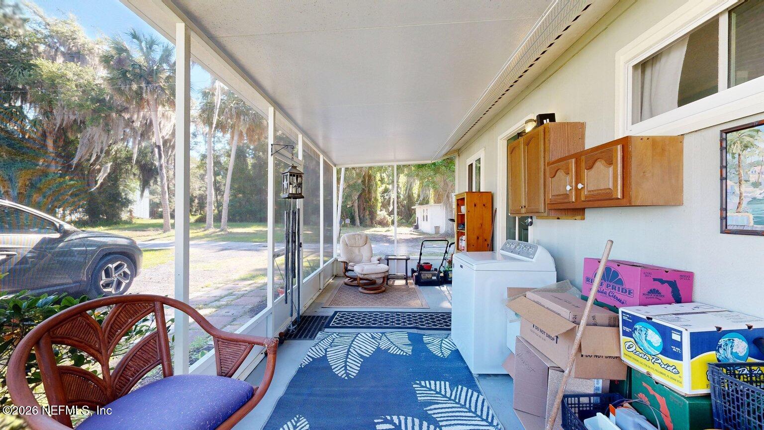 101 Possum Hollow Road Georgetown, FL 32139 - Photo 13 of 17 a living room with furniture and a floor to ceiling window
