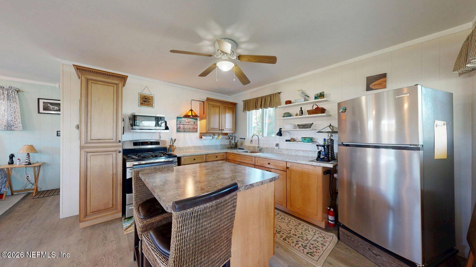 101 Possum Hollow Road Georgetown, FL 32139 - Photo 3 of 17 a kitchen with stainless steel appliances and a refrigerator