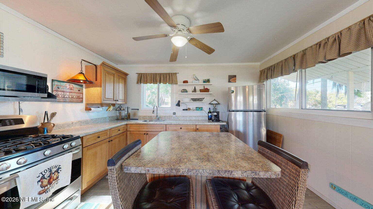 101 Possum Hollow Road Georgetown, FL 32139 - Photo 6 of 17 a kitchen with stainless steel appliances granite countertop a stove oven and a refrigerator